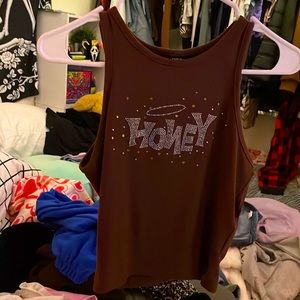 its a rhinestone shirt that says honey and its ling shirt not a crop top lmao
